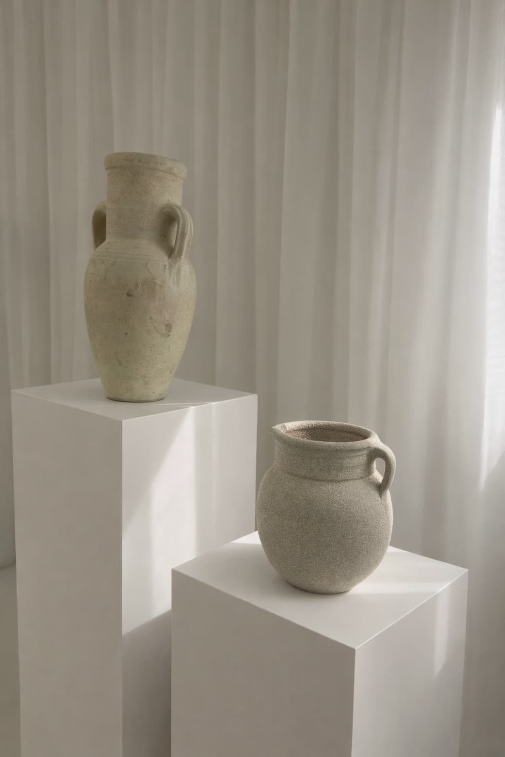 Styled ceramic vases on plinths, product photography setup