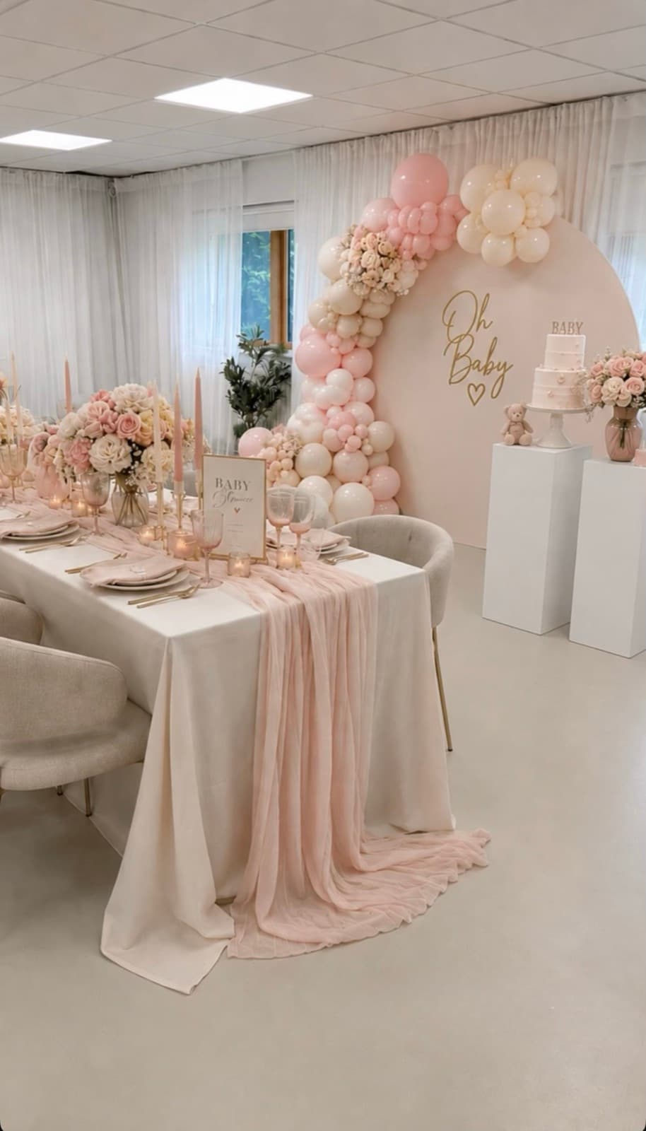 Pastel balloon arch and styled tablescape set up for a baby shower celebration